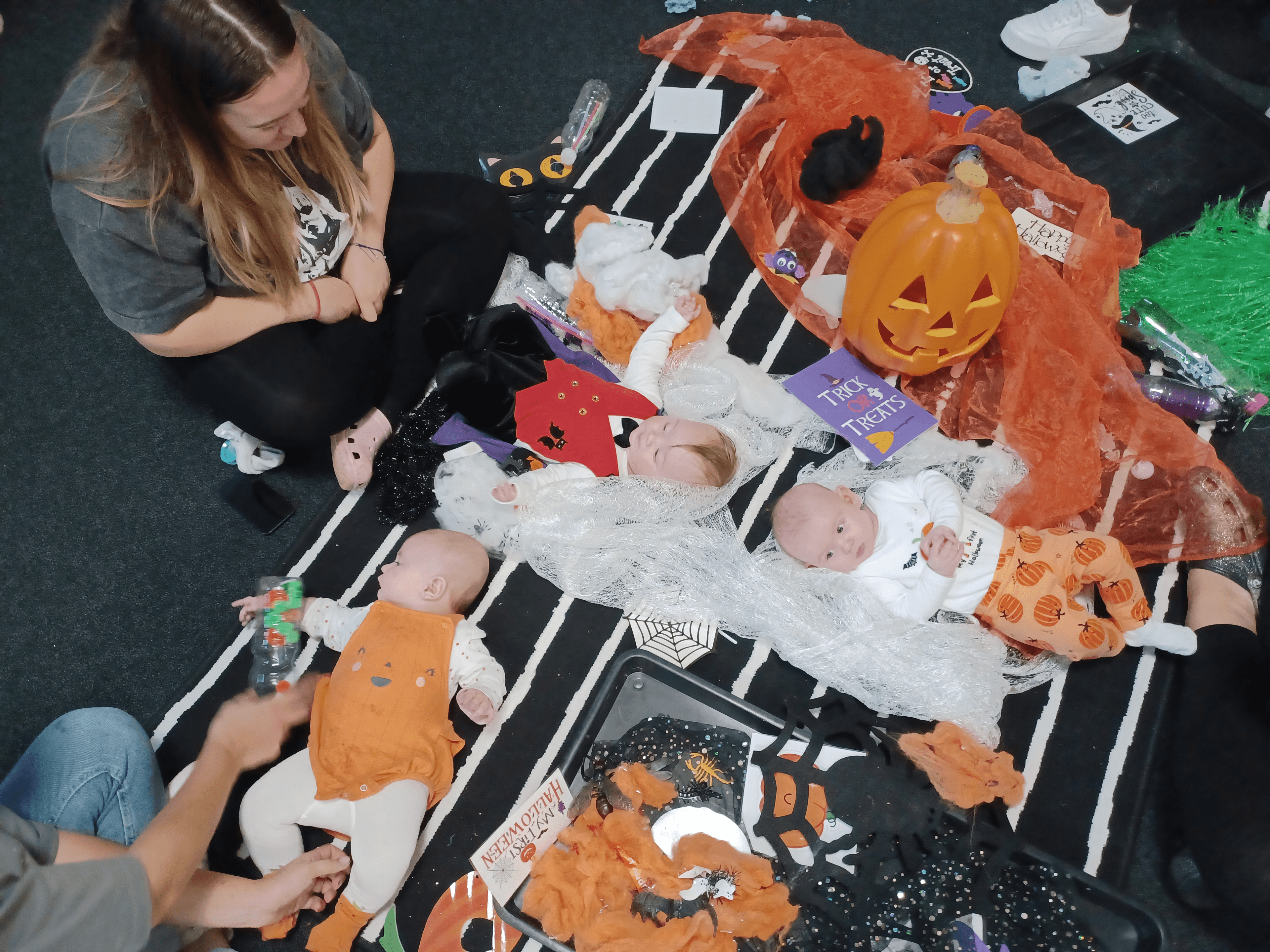 Babies exploring Halloween themed items