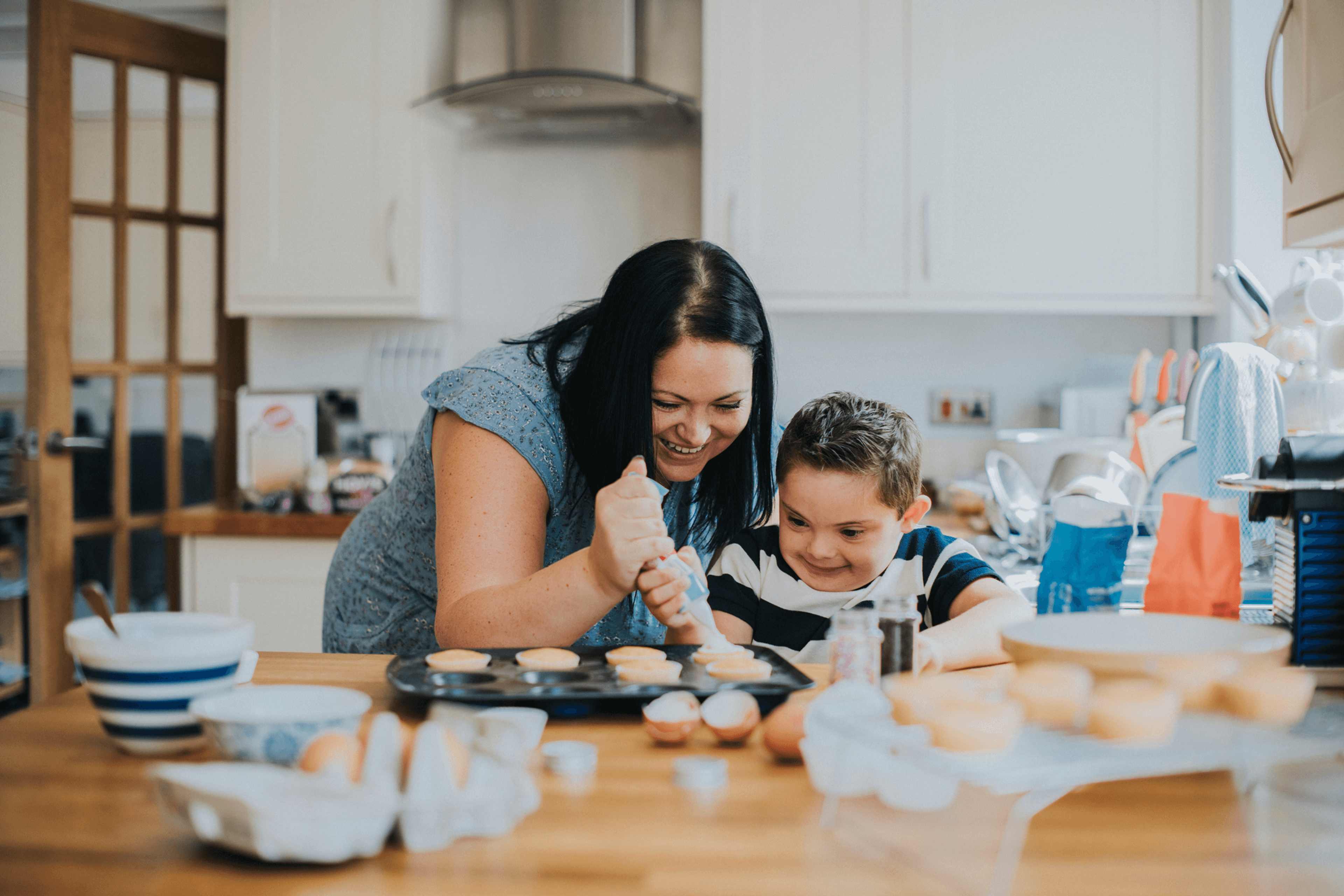 Mam baking cupcakes with her child