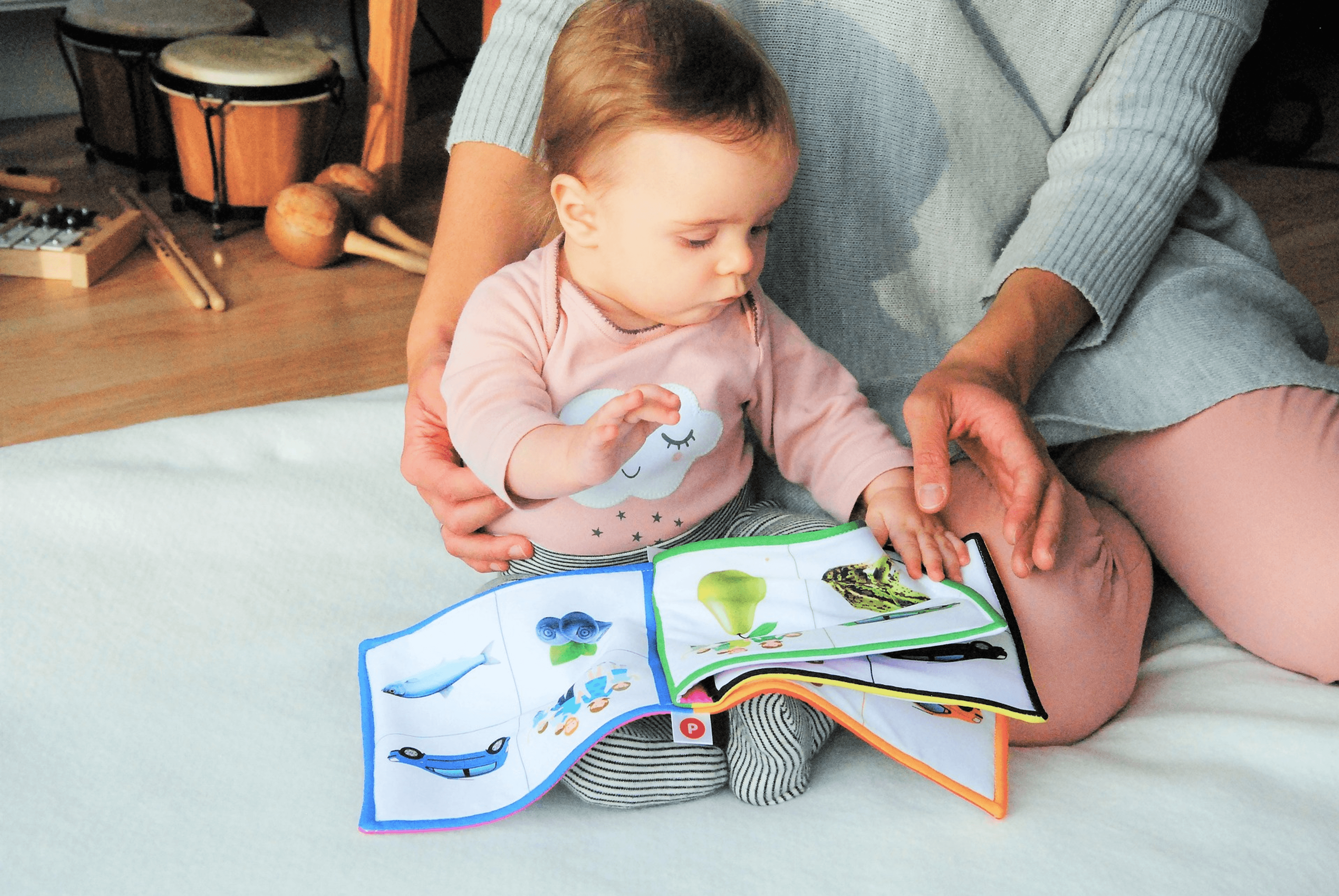 Adult reading a picture book with toddler