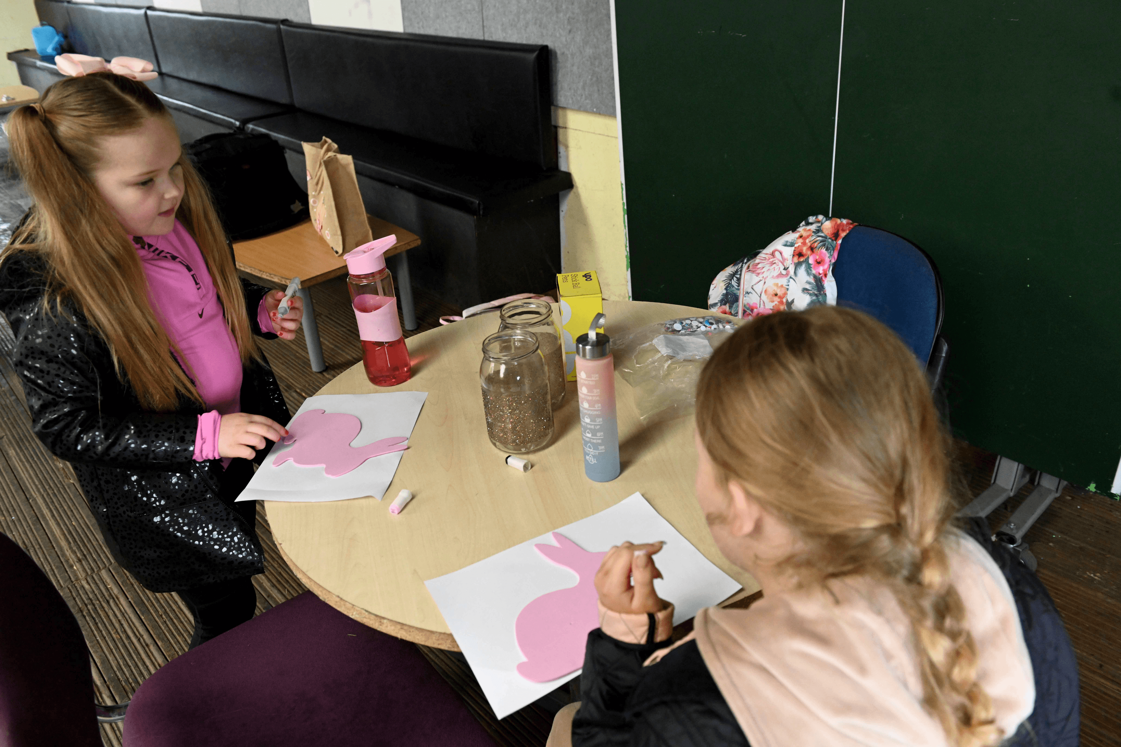 2 young girls doing arts and crafts